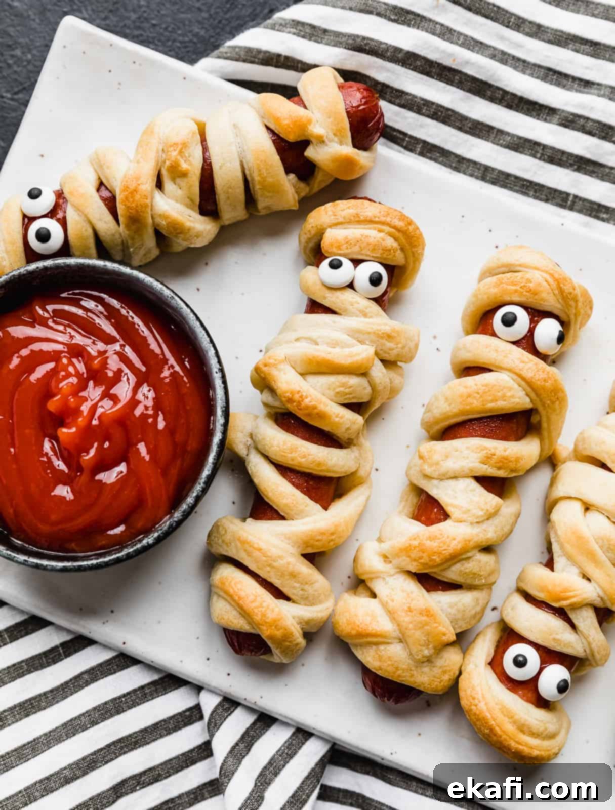 Mummy Hot Dogs 2 A hot dog wrapped in crescent roll strips.