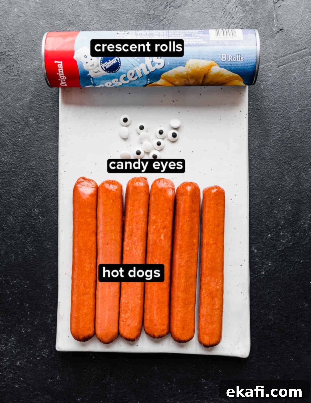 Mummy Hot Dogs 3 Mummy Hot Dogs ingredients on a rectangular white plate.