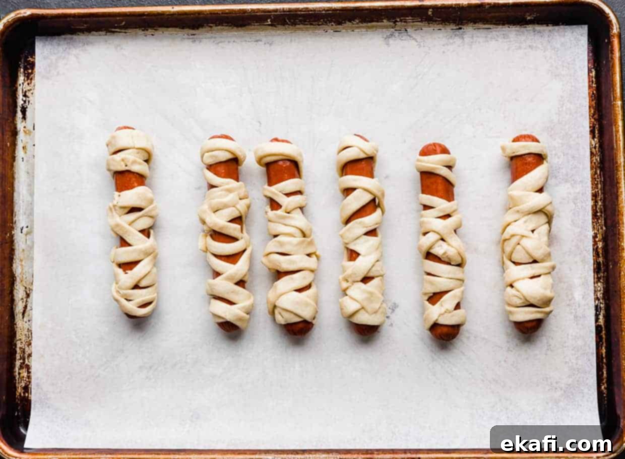 Mummy Hot Dogs 6 Hot dogs wrapped in crescent roll strips.
