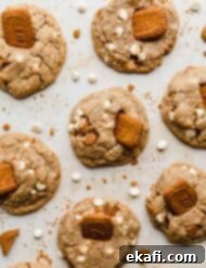 Crumbl's Dreamy Biscoff White Chocolate Cookies 7 Crumbl Biscoff White Chip Cookies on a tan background.