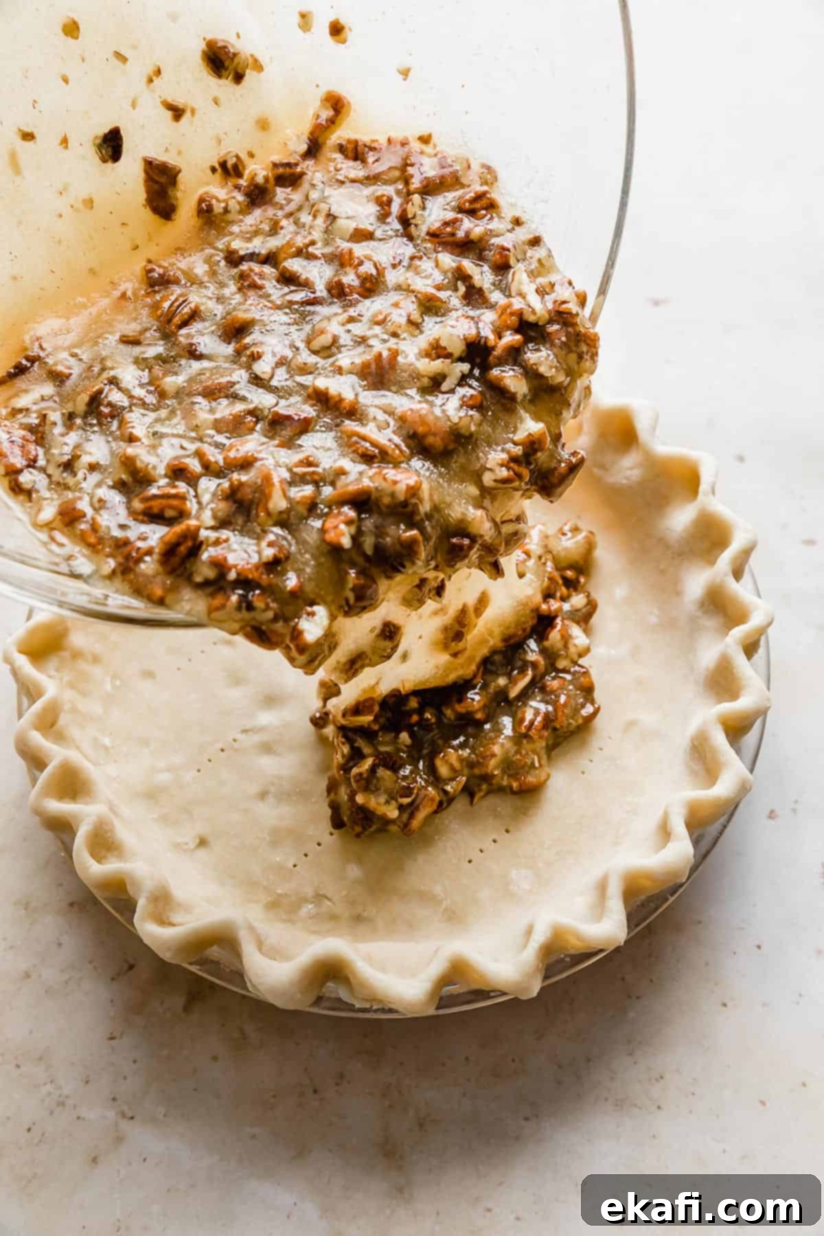 Sweet Southern Comfort: The Perfect Pecan Pie 6 Rich pecan pie filling being carefully poured into a golden, unbaked pie crust, set in a pie dish.