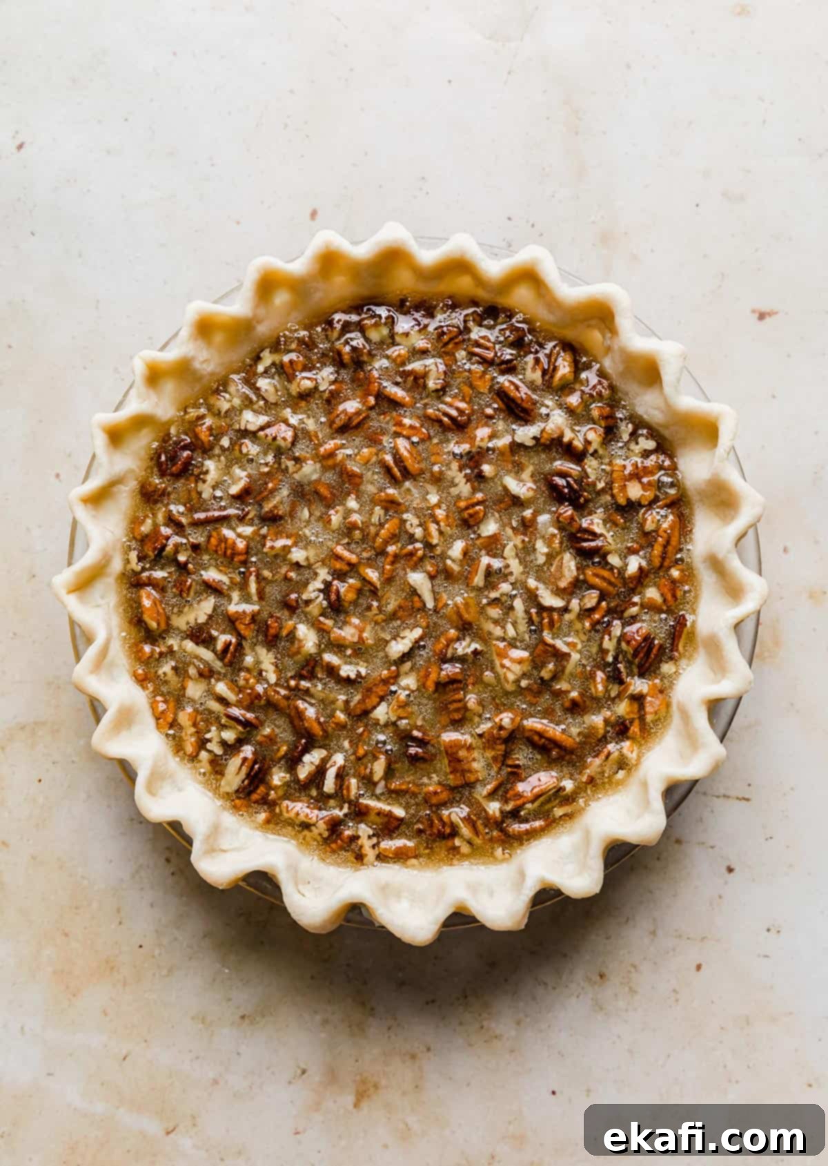 Sweet Southern Comfort: The Perfect Pecan Pie 7 An unbaked Southern Pecan Pie, with the filling perfectly poured into the crust and the pecans visible on top, ready for the oven.