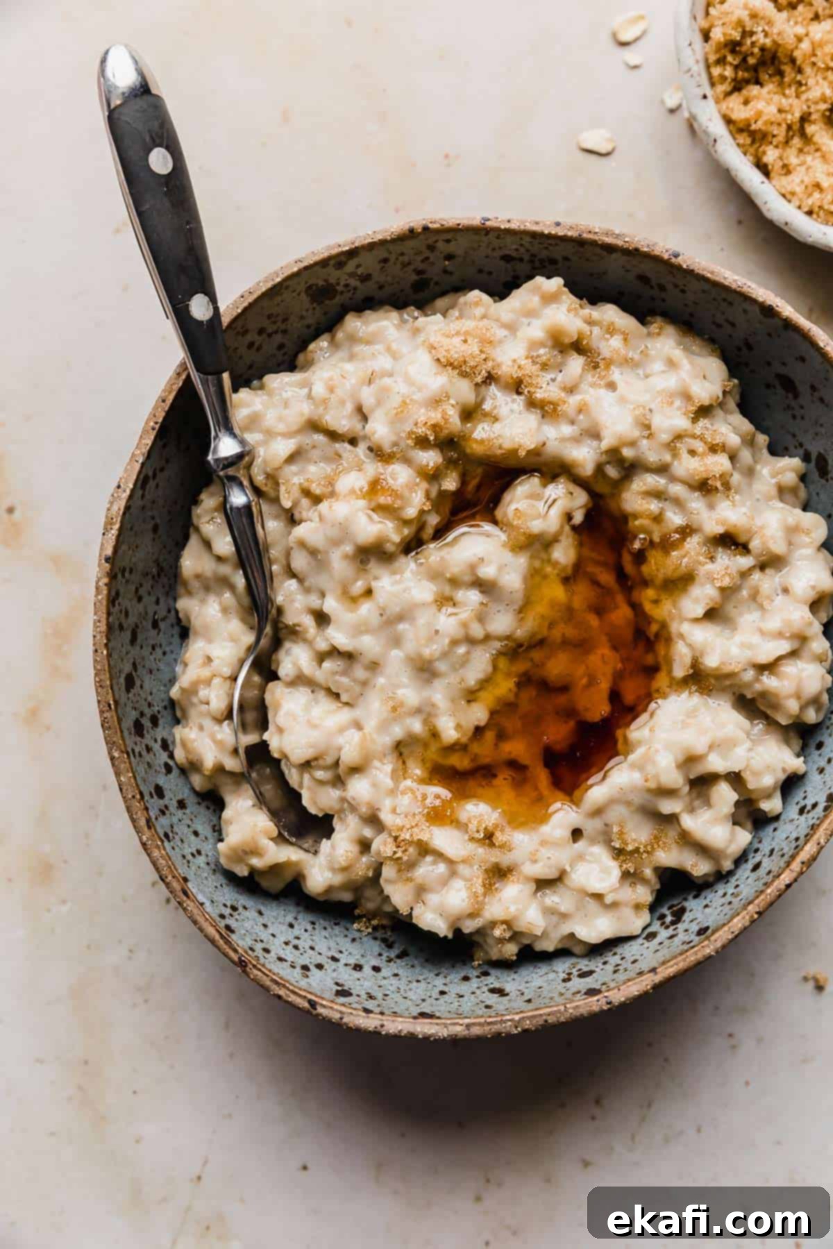 Golden Maple Brown Sugar Oats 6 Maple syrup overtop a batch of Maple and Brown Sugar Oatmeal in a bowl.