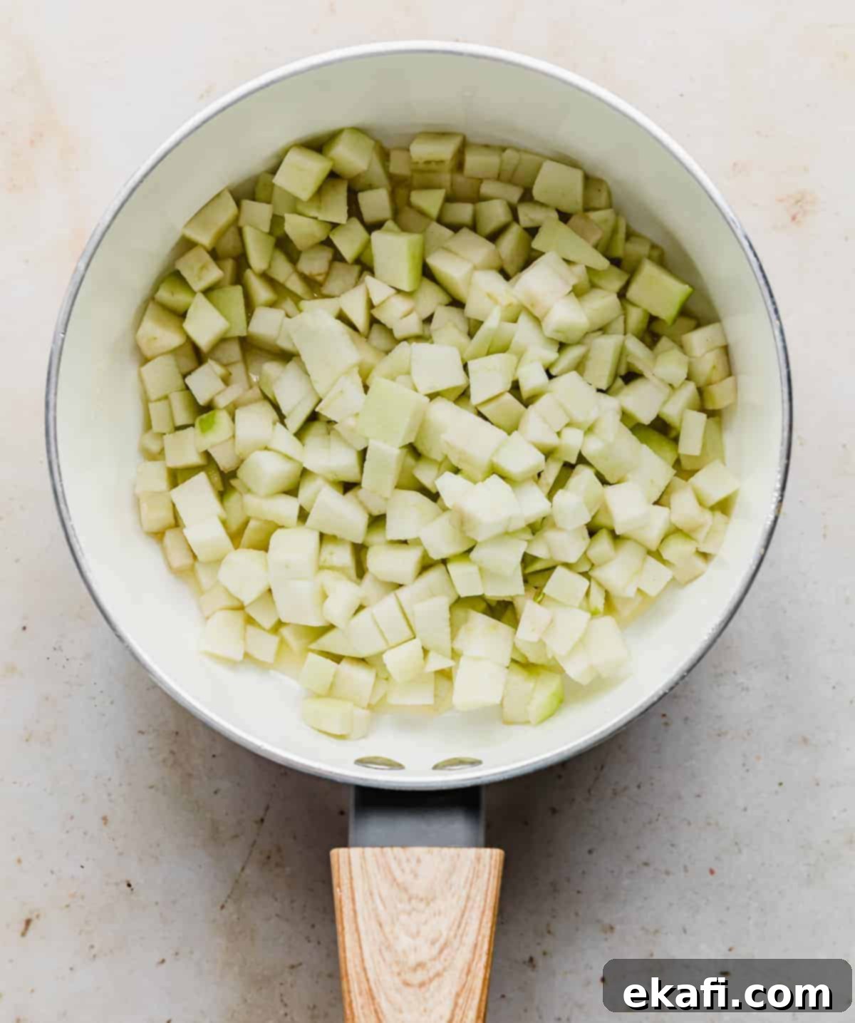 Flaky Apple Turnovers 4 Diced apples in a white saucepan.