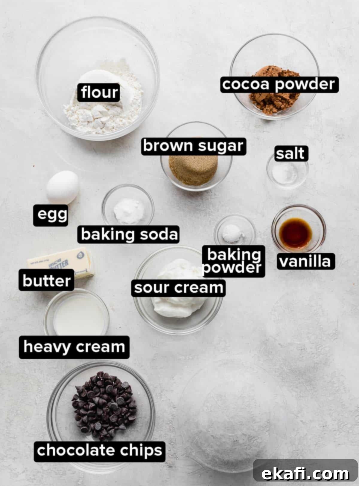 Ultimate Chocolate Donuts 3 A selection of fresh ingredients for baking chocolate doughnuts laid out on a stylish gray background.