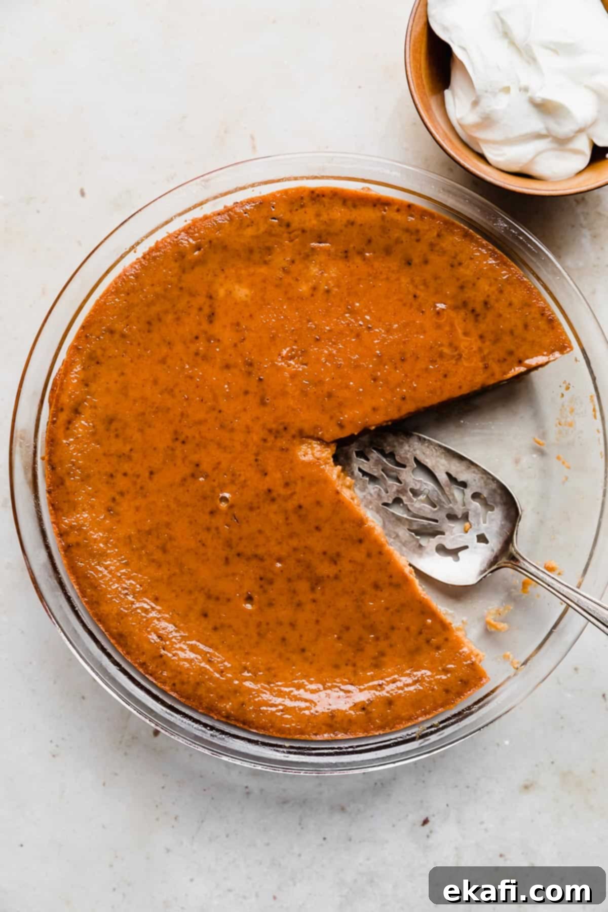 Pure Pumpkin Custard 9 A freshly baked Crustless Pumpkin Pie with a perfect slice removed, showcasing its smooth, creamy interior texture, ready to be enjoyed.