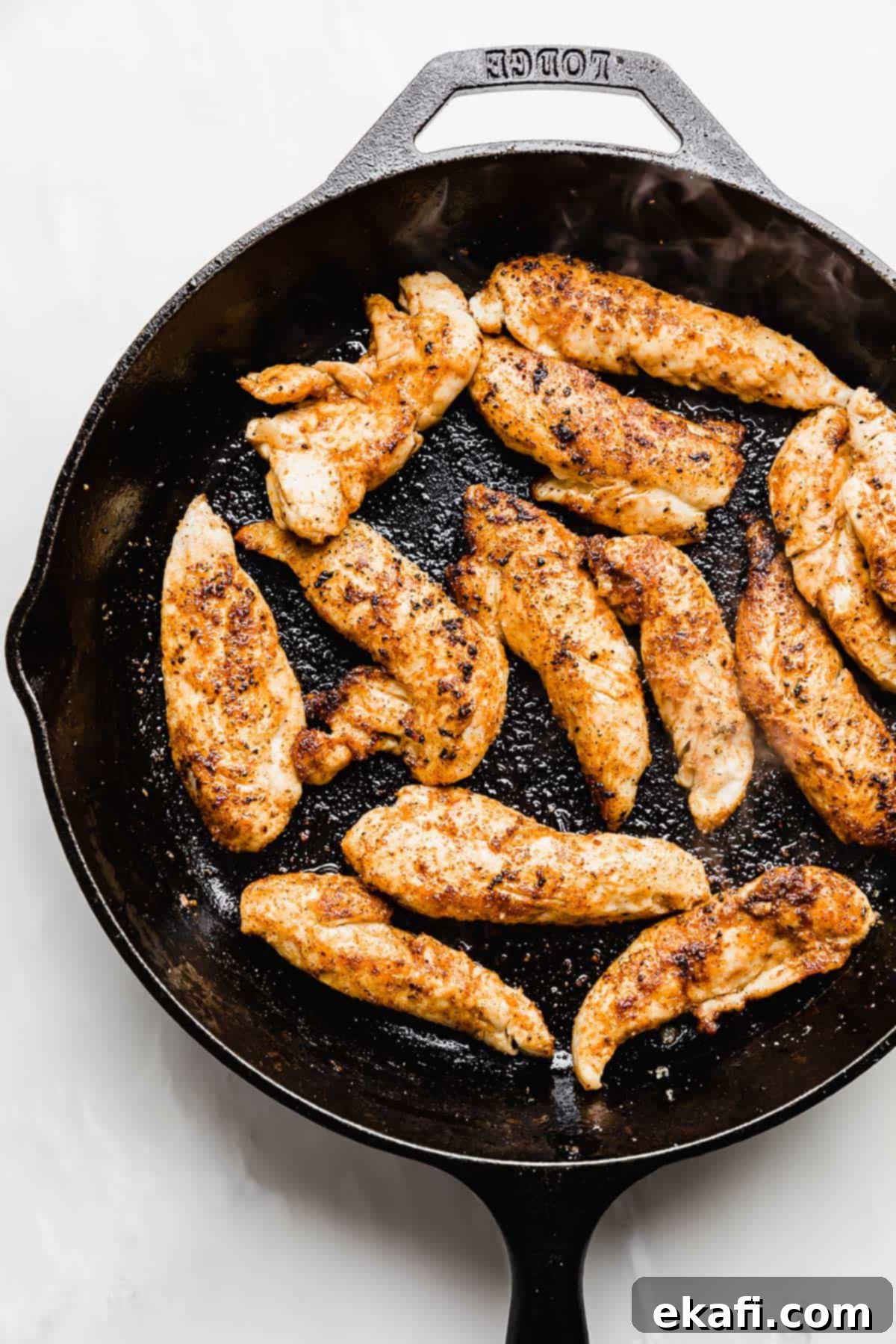 Tuscan Garlic Cream Chicken 4 Browned chicken tenders in a cast iron skillet.