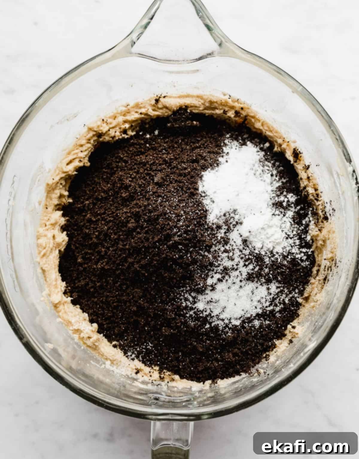 Craft Your Own Chocolate Cream Sandwiches 6 A glass bowl with black cocoa powder, crushed Oreos, salt, baking powder, and baking soda in it.