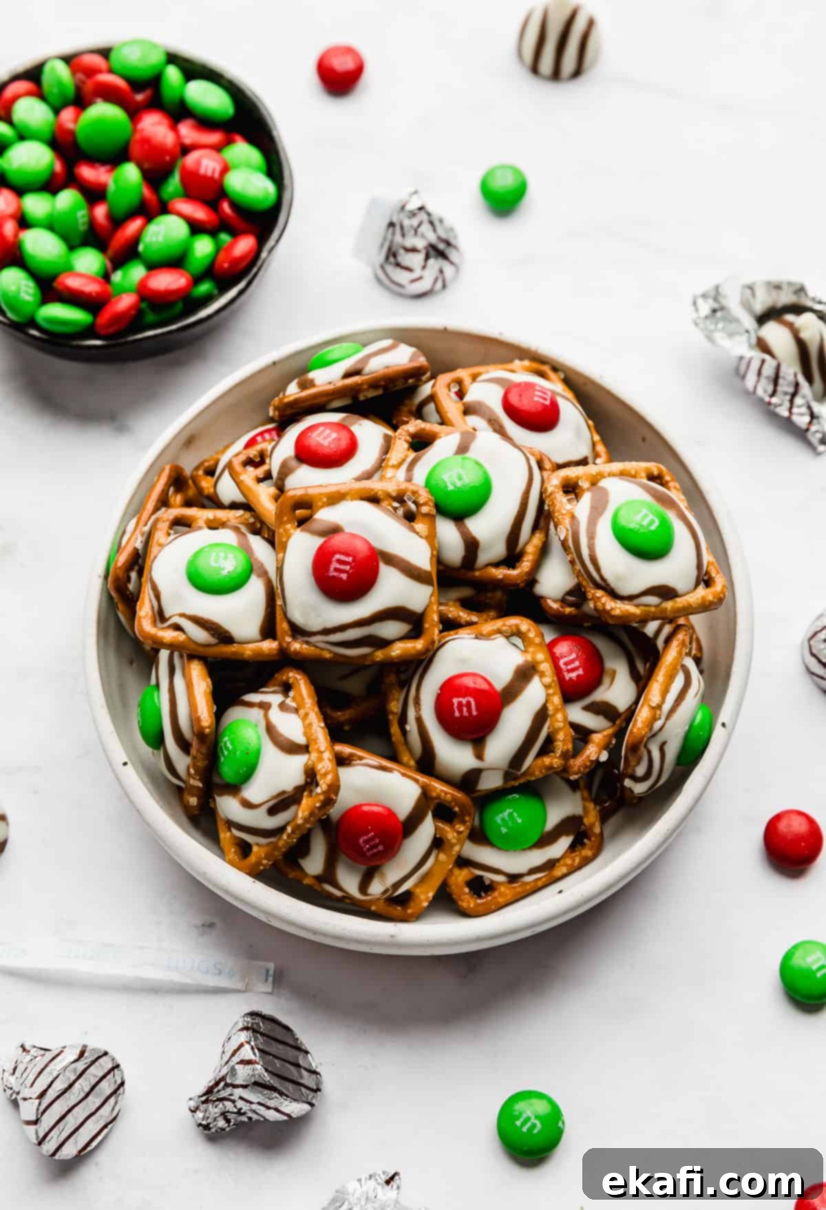 Christmas Pretzel Hugs 6 A white bowl full of Christmas Pretzel Hugs on a white background, ready to be enjoyed.