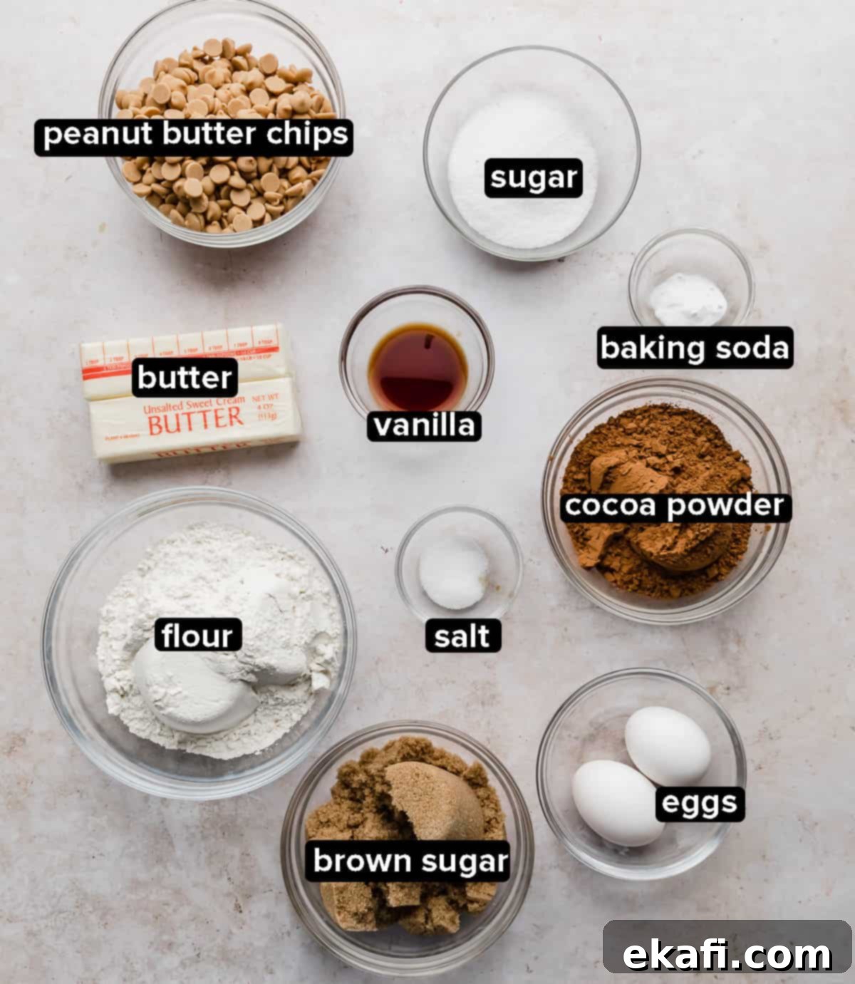 Decadent Peanut Butter Chocolate Chip Cookies 3 Assortment of Crumbl Chocolate Peanut Butter Chip Cookies ingredients, including butter, sugar, flour, cocoa, and peanut butter chips, displayed in glass bowls.