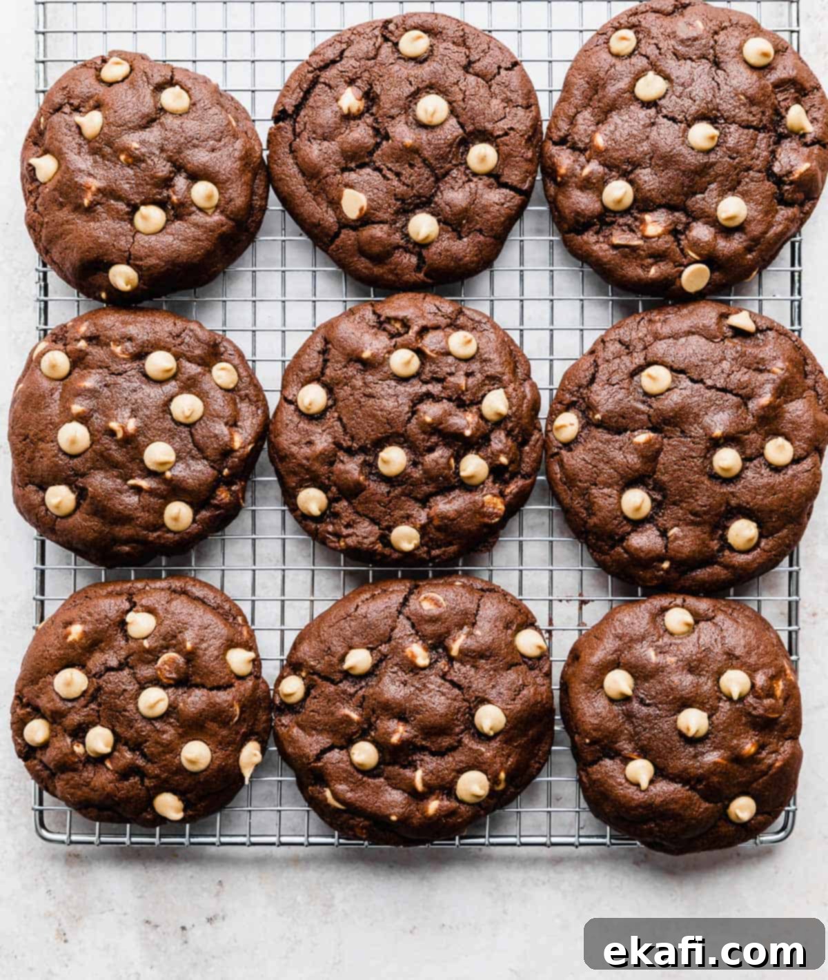 Decadent Peanut Butter Chocolate Chip Cookies 6 Freshly baked Crumbl Chocolate Peanut Butter Chip Cookies cooling on a wire rack, showcasing their perfect texture and vibrant chips.
