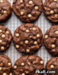 Decadent Peanut Butter Chocolate Chip Cookies 9 Chocolate Peanut Butter Chip Cookies lined up next to each other on a wire rack.