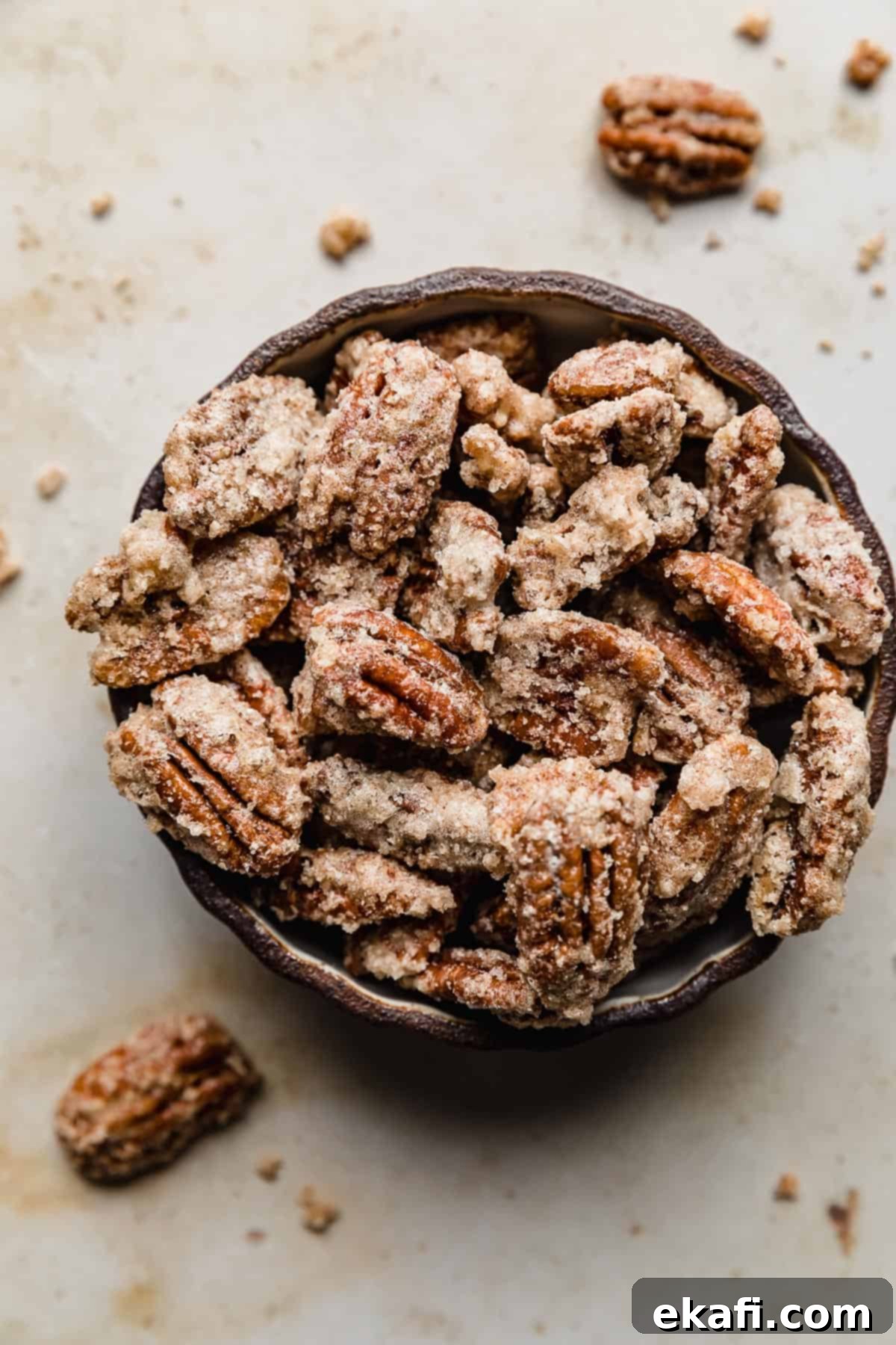Sweet Glazed Pecans 2 Crunchy cinnamon candied pecans in a black serving bowl, perfect for a holiday snack.