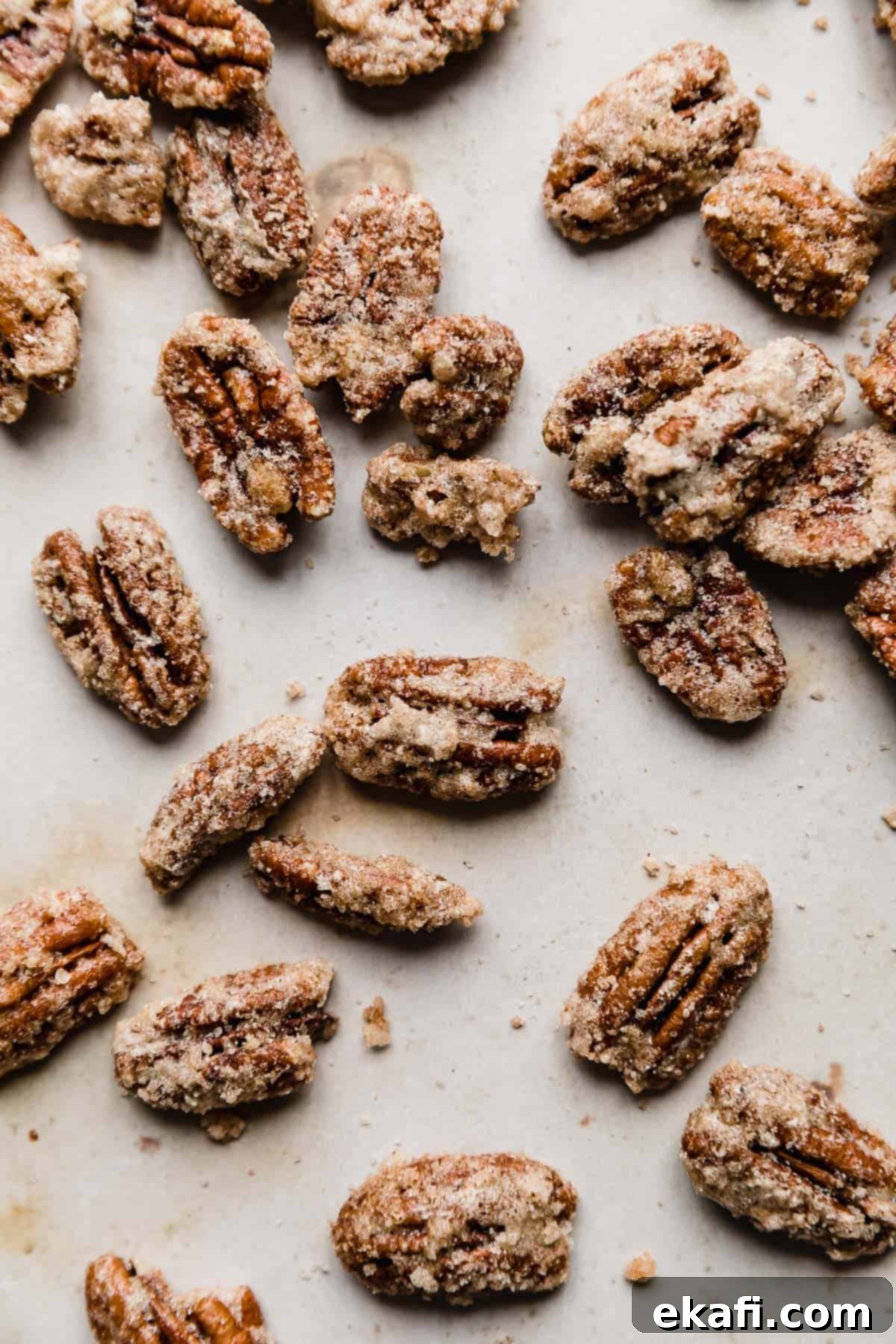 Sweet Glazed Pecans 11 Golden-brown roasted candied pecans displayed on a tan marble background.