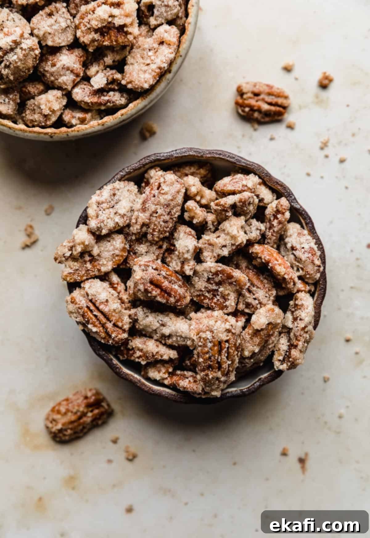 Sweet Glazed Pecans 12 Two bowls brimming with golden, sugared candied pecans, ready to serve.