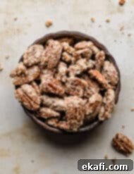 Sweet Glazed Pecans 13 A black bowl overflowing with perfectly sugared candied pecans.
