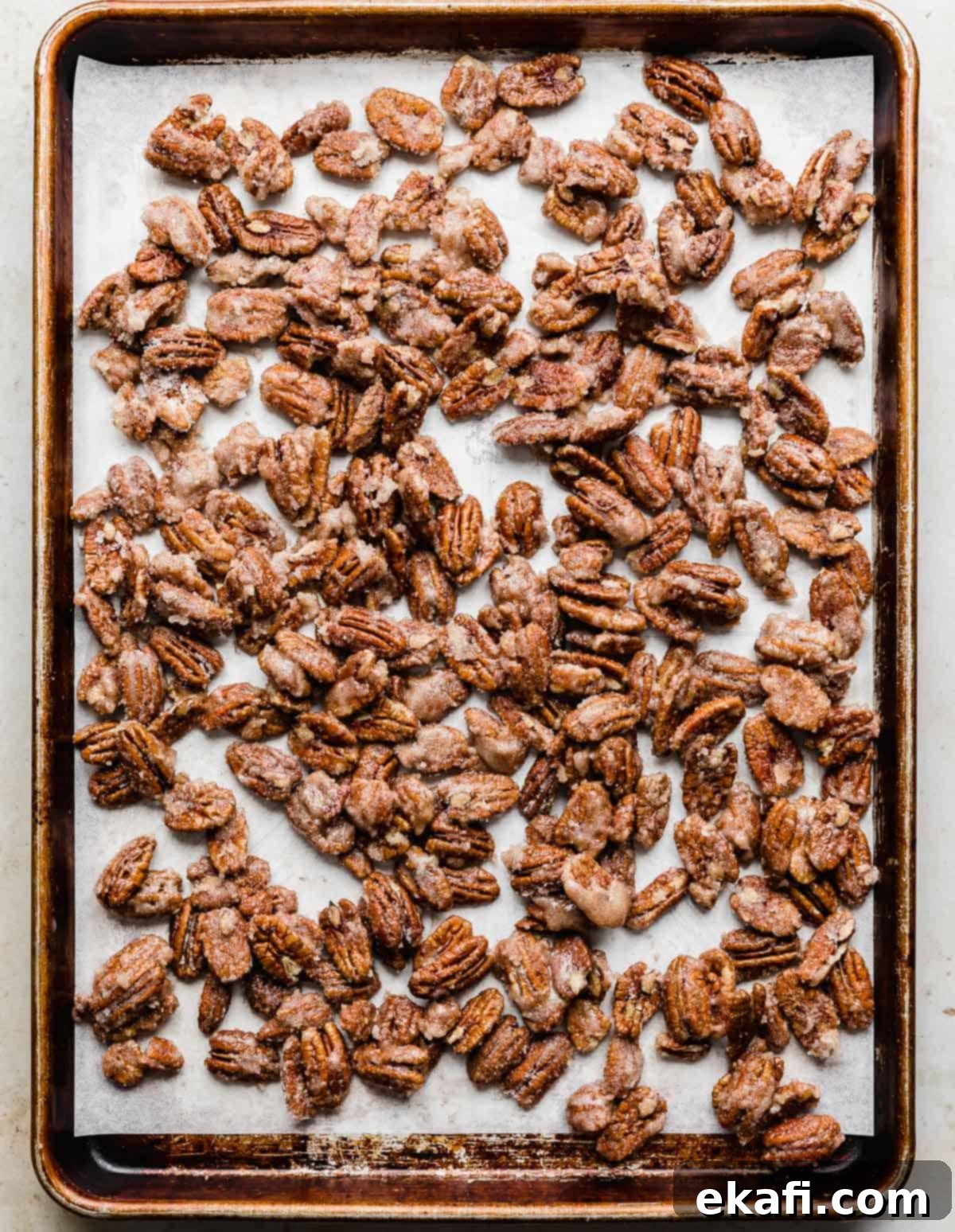 Sweet Glazed Pecans 9 Roasted candied pecans cooling on a baking sheet, glistening with sugar.