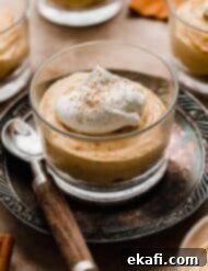 Quick Pumpkin Cheesecake Minis 9 Mini No-Bake Pumpkin Cheesecake in a glass cup, topped with whipped cream and pumpkin pie spice.