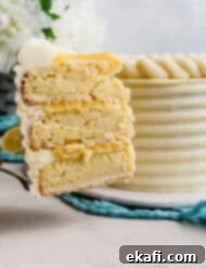 Zesty Lemon Bar Cake 15 A slice of lemon bar cake on a spatula.