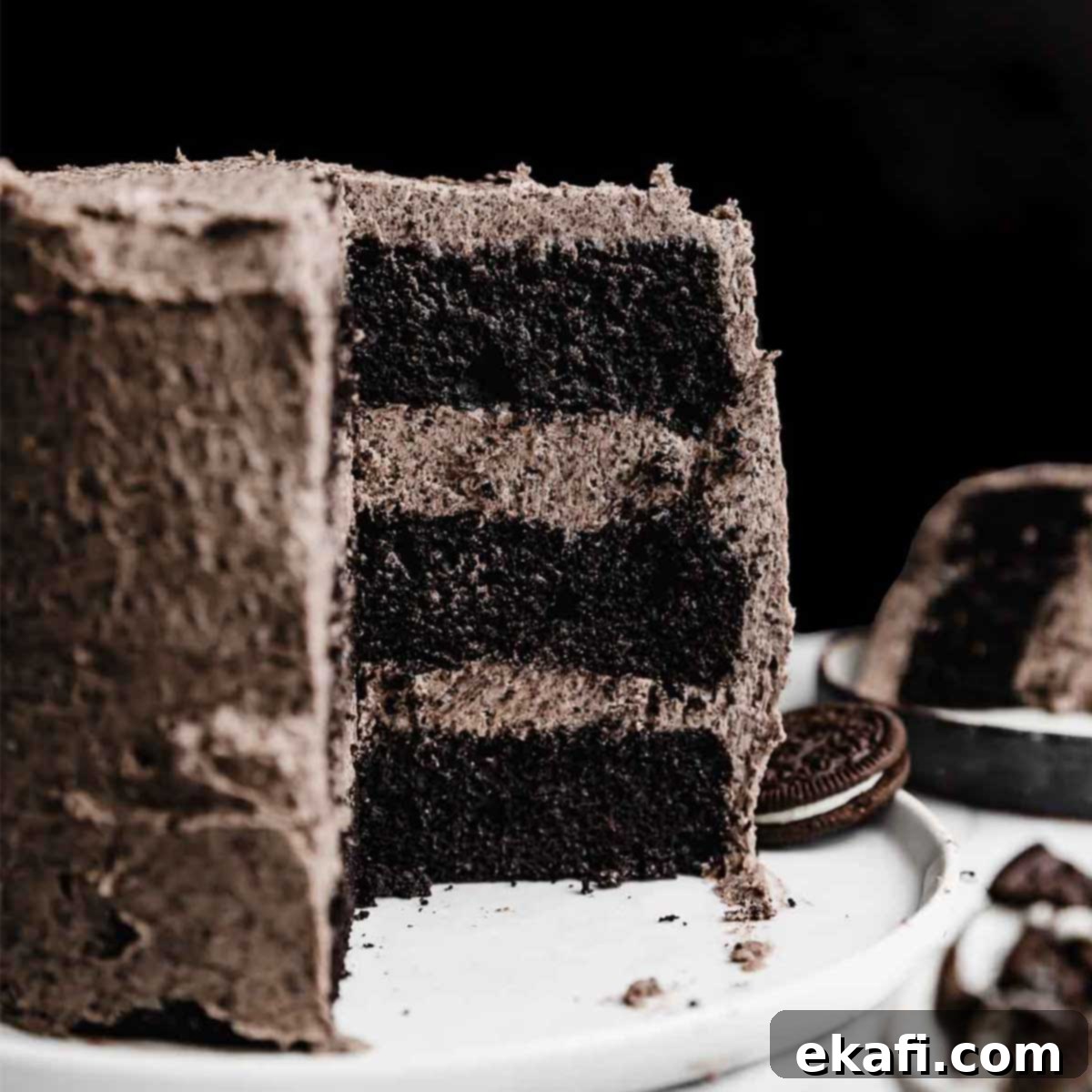 Irresistible Oreo Desserts 9 A three layer six inch Oreo Cake recipe topped with an Oreo frosting, against a black background.