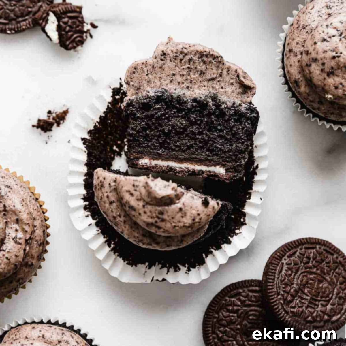 Irresistible Oreo Desserts 10 An Oreo Cupcake topped with Oreo frosting, that has been cut in half, exposing a full sized oreo on the bottom of the cupcake.