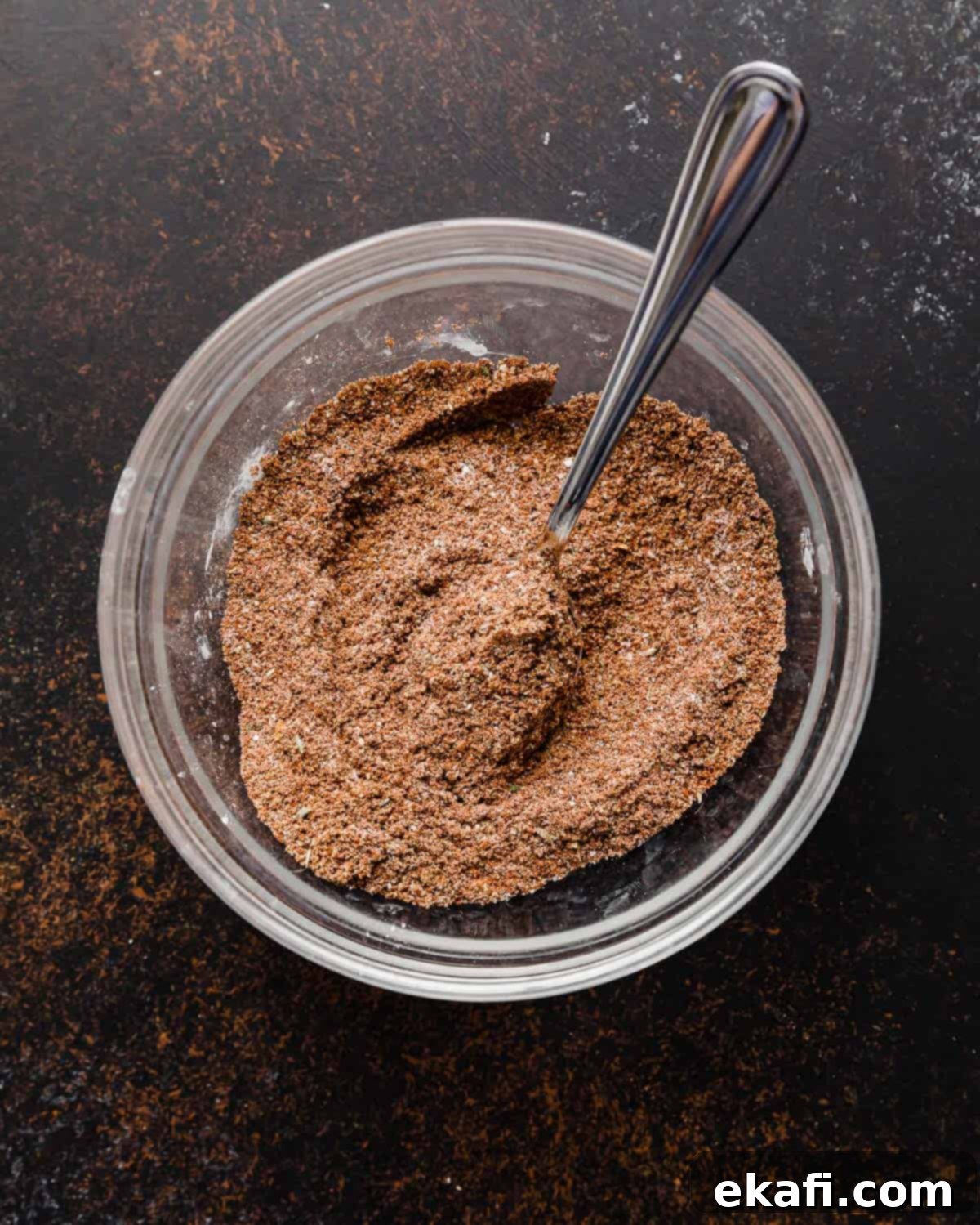 Mellow Fiesta Seasoning 4 A glass bowl filled with freshly mixed homemade taco seasoning, showing the texture and blend of spices.