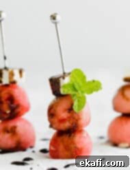 Cool Watermelon Sticks 10 Three Watermelon Feta Skewers with balsamic reduction overtop, garnished with mint.