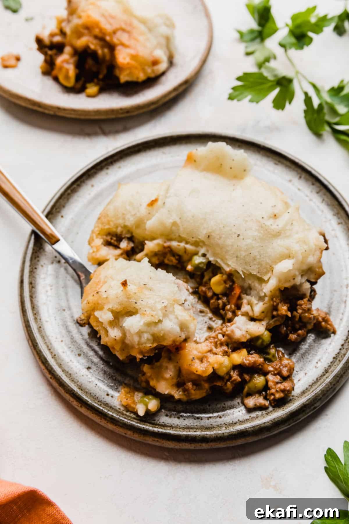 Hearty Lamb Potato Casserole 2 A generous chunk of Easy Shepherd's Pie on a stylish gray plate, showcasing the golden mashed potato crust and rich, savory filling beneath.