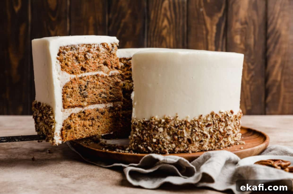 Tropical Pecan Carrot Cake 9 A delectable slice of moist carrot cake, generously topped with luscious cream cheese frosting, is being carefully lifted from the main, freshly baked Carrot Cake.