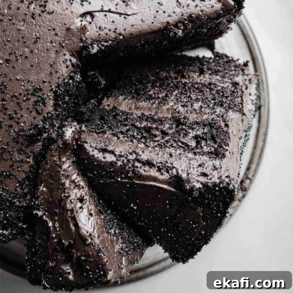 Deep & Dark Black Cocoa Delights 5 Overhead photo of a Black Velvet Cake with a slice leaning sideways against the full layered cake.