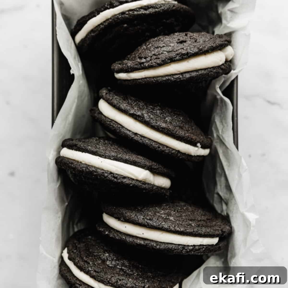 Deep & Dark Black Cocoa Delights 6 Homemade Oreo Sandwich Cookies in a parchment lined bread pan.