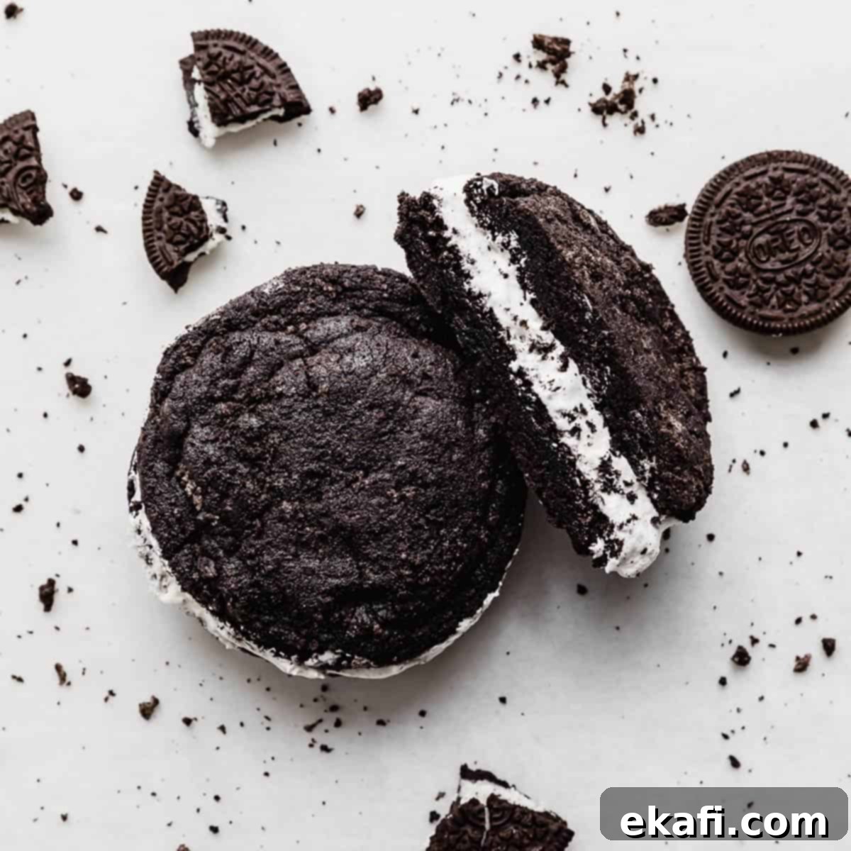 Deep & Dark Black Cocoa Delights 8 A copycat Crumbl Oreo cookie sandwich on a white background with Oreo crumbs surrounding the cookie.