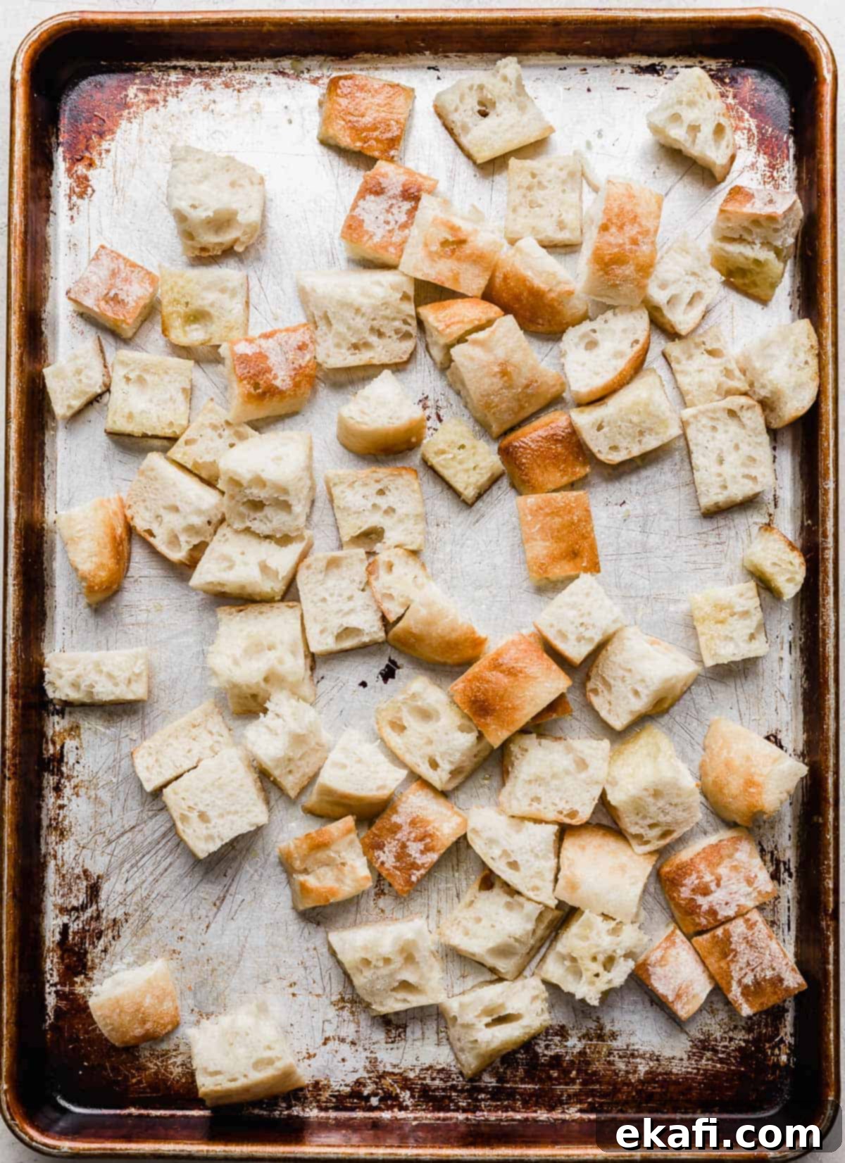 Rustic Tuscan Panzanella 6 A baking sheet with cubed artisan bread on it.