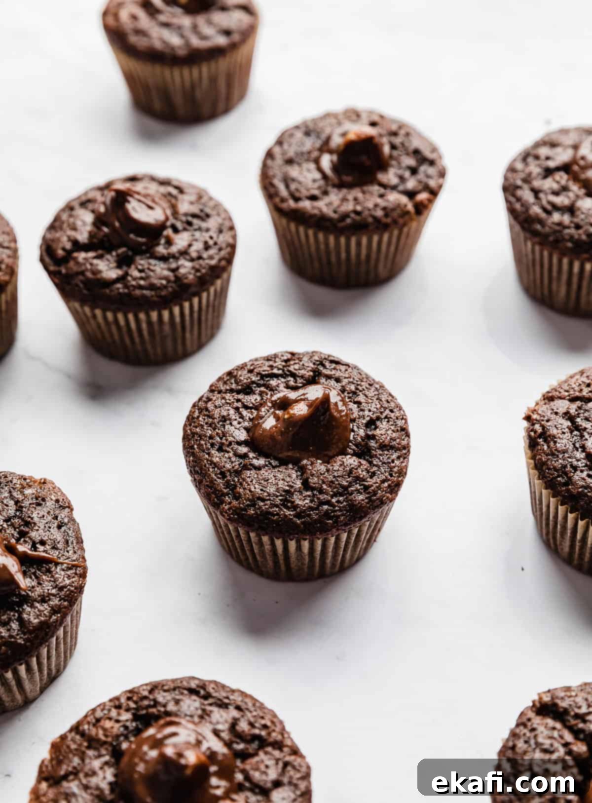 Decadent Ferrero Rocher Cupcakes 10 Nutella filled chocolate hazelnut cupcake on a white background.
