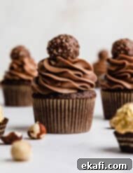 Decadent Ferrero Rocher Cupcakes 13 Ferrero Rocher Cupcakes topped with a swirl of chocolate frosting and a Ferrero Rocher candy.