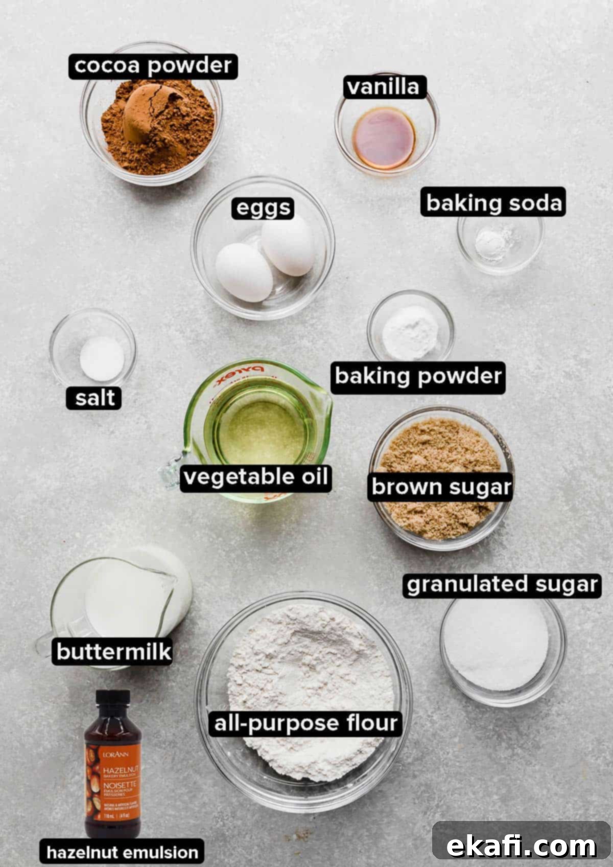 Decadent Ferrero Rocher Cupcakes 3 Ferrero Rocher Cupcake ingredients portioned into glass bowls on a gray background.