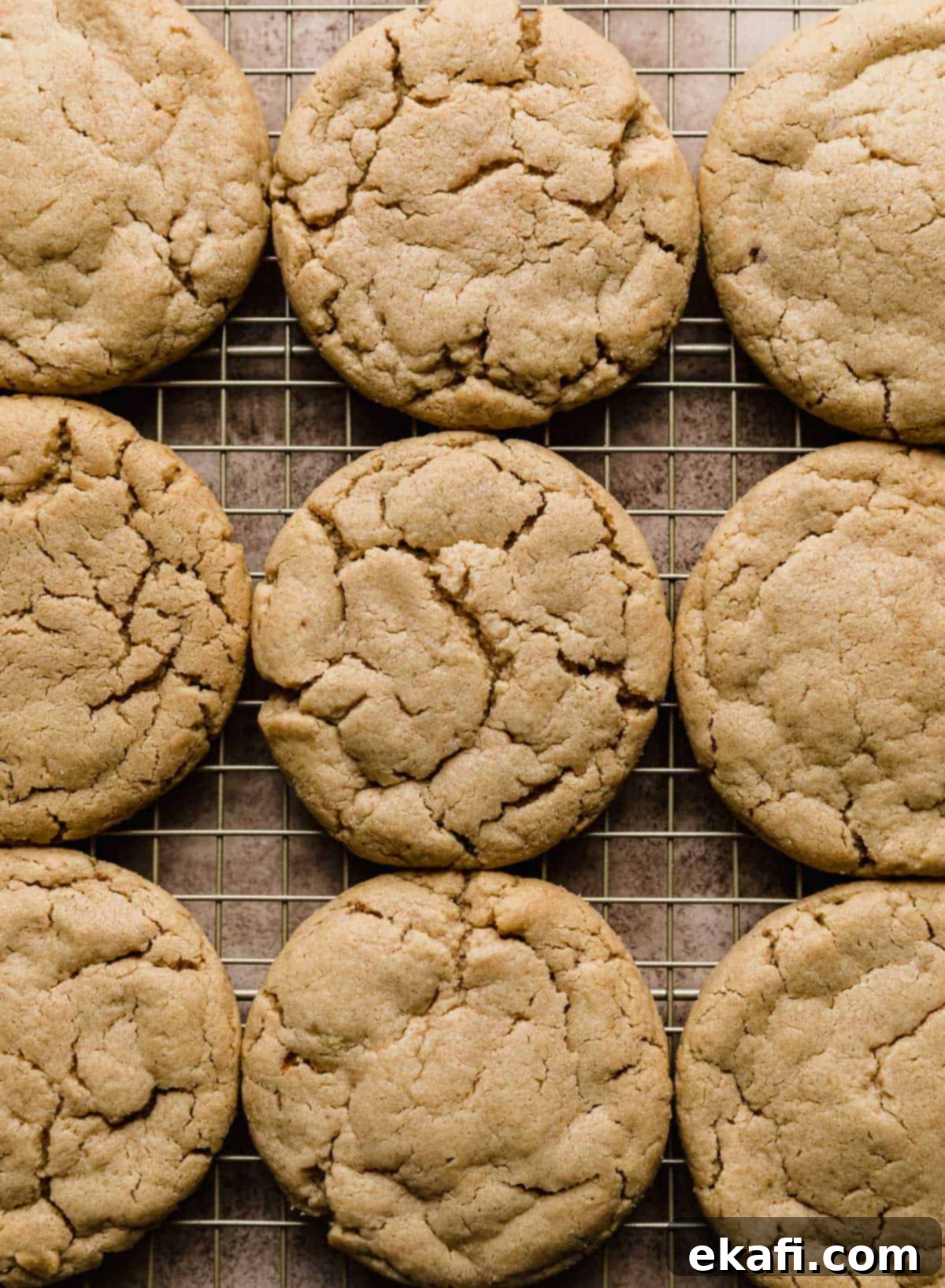 Decadent Peanut Butter Cup Cookies 5 Baked Crumbl Peanut Butter Cup Cookies on a wire cooling rack.