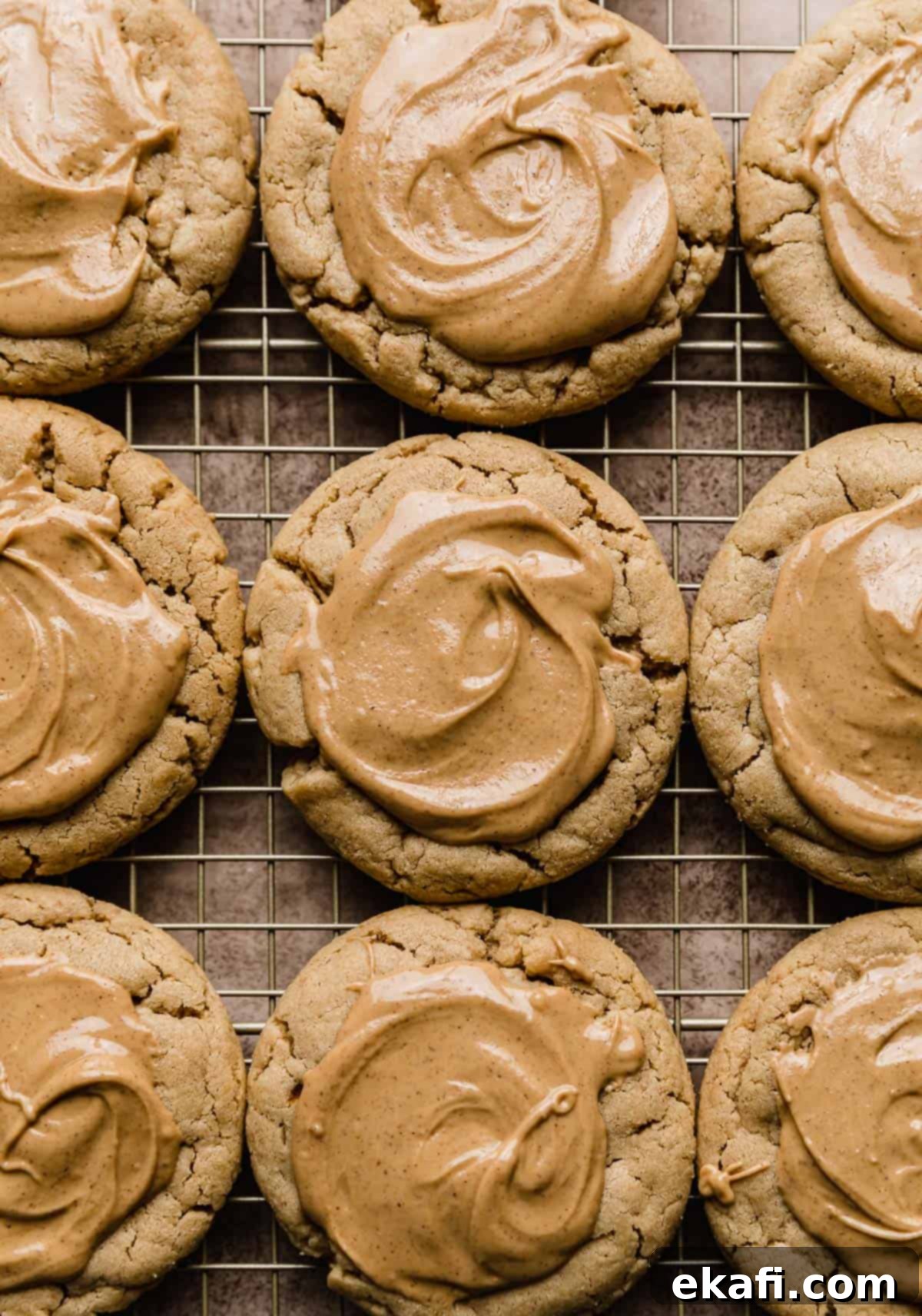 Decadent Peanut Butter Cup Cookies 7 Peanut butter cookies topped with a smooth melted peanut butter topping on a wire rack.