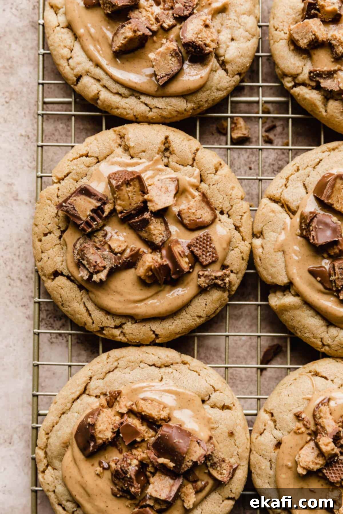 Decadent Peanut Butter Cup Cookies 9 Crumbl Peanut Butter Cup Cookies on a wire cooling rack.