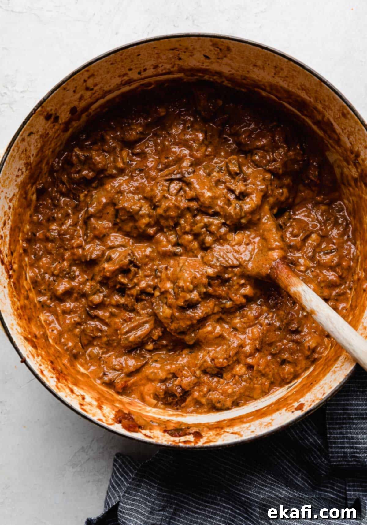 Hearty Shredded Beef Ragu 13 Shredded beef Ragu and sauce in a pot.