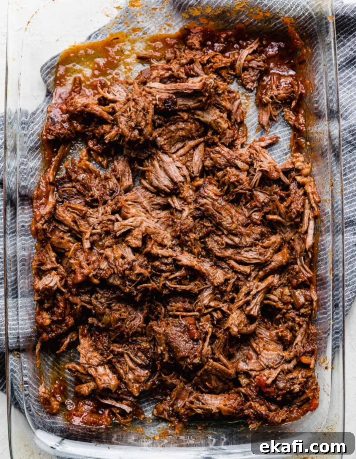 Hearty Shredded Beef Ragu 10 Shredded beef in a glass baking dish for making the best beef Ragu recipe.
