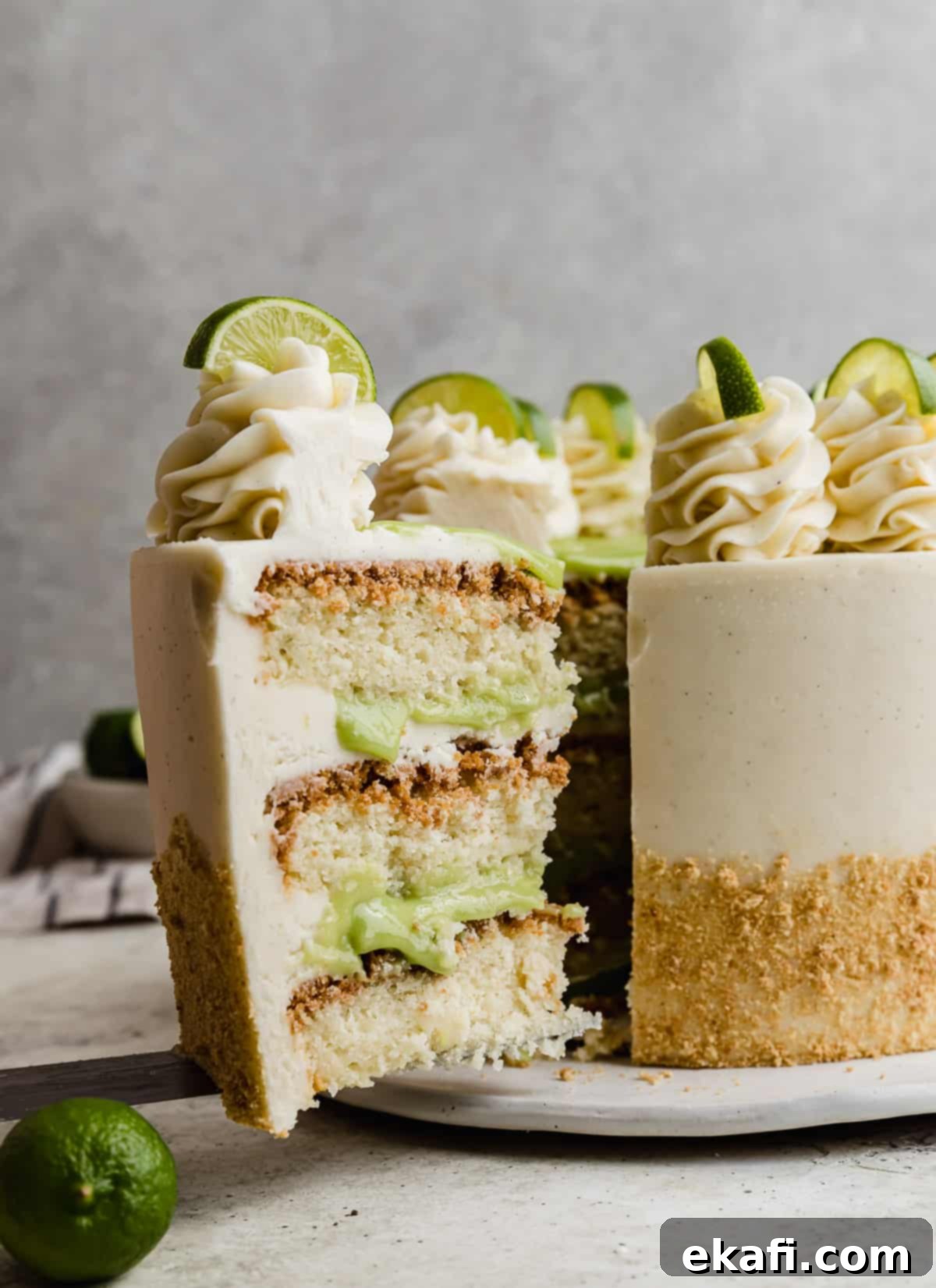 Key Lime Dream Cake 9 A slice of Key Lime Cake in front of a grey background.