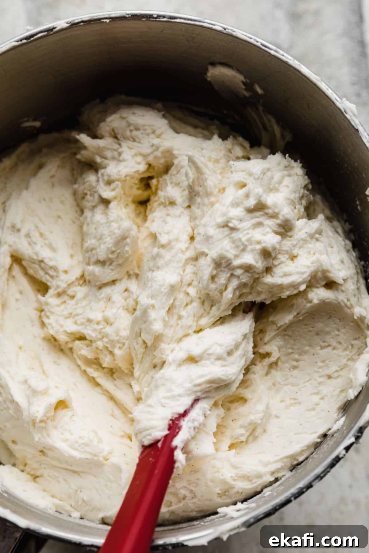 Key Lime Dream Cake 6 Vanilla bean buttercream frosting in a metal mixing bowl.