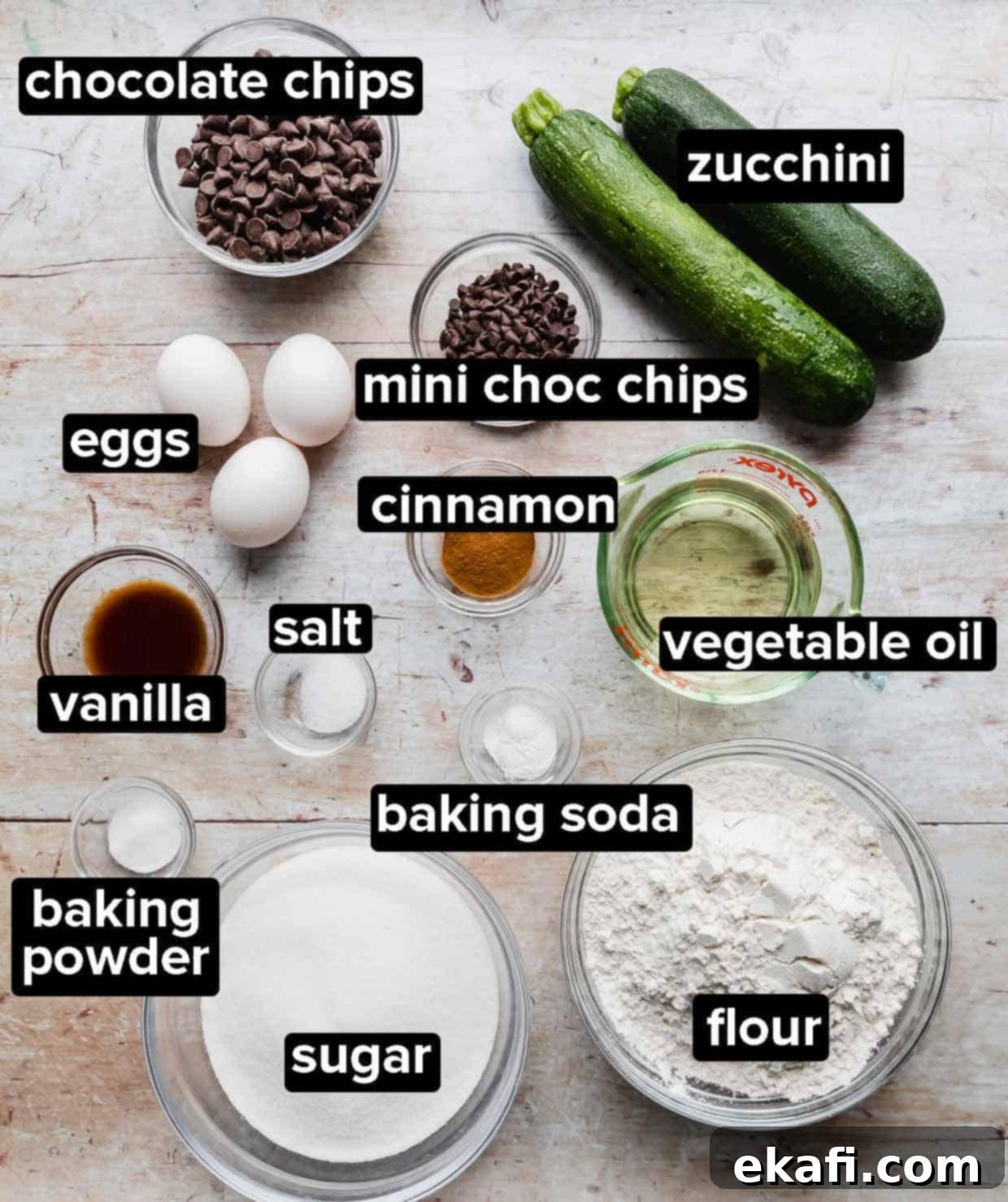 Decadent Chocolate Chip Zucchini Loaf 3 All the fresh ingredients needed to make a delicious batch of chocolate chip zucchini bread, laid out on a light wooden background.