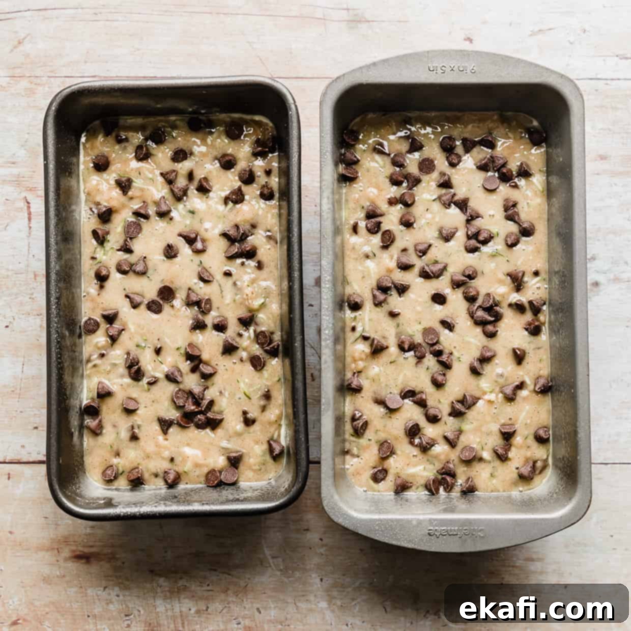 Decadent Chocolate Chip Zucchini Loaf 10 Two loaf pans filled with raw Chocolate Chip Zucchini Bread batter, ready for baking.