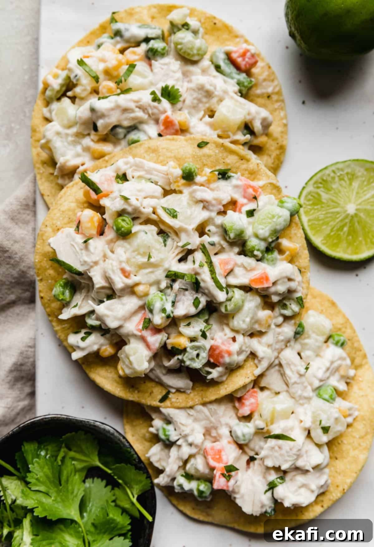Mexican Chicken Salad 2 Mexican Chicken Salad tostadas on a white plate.