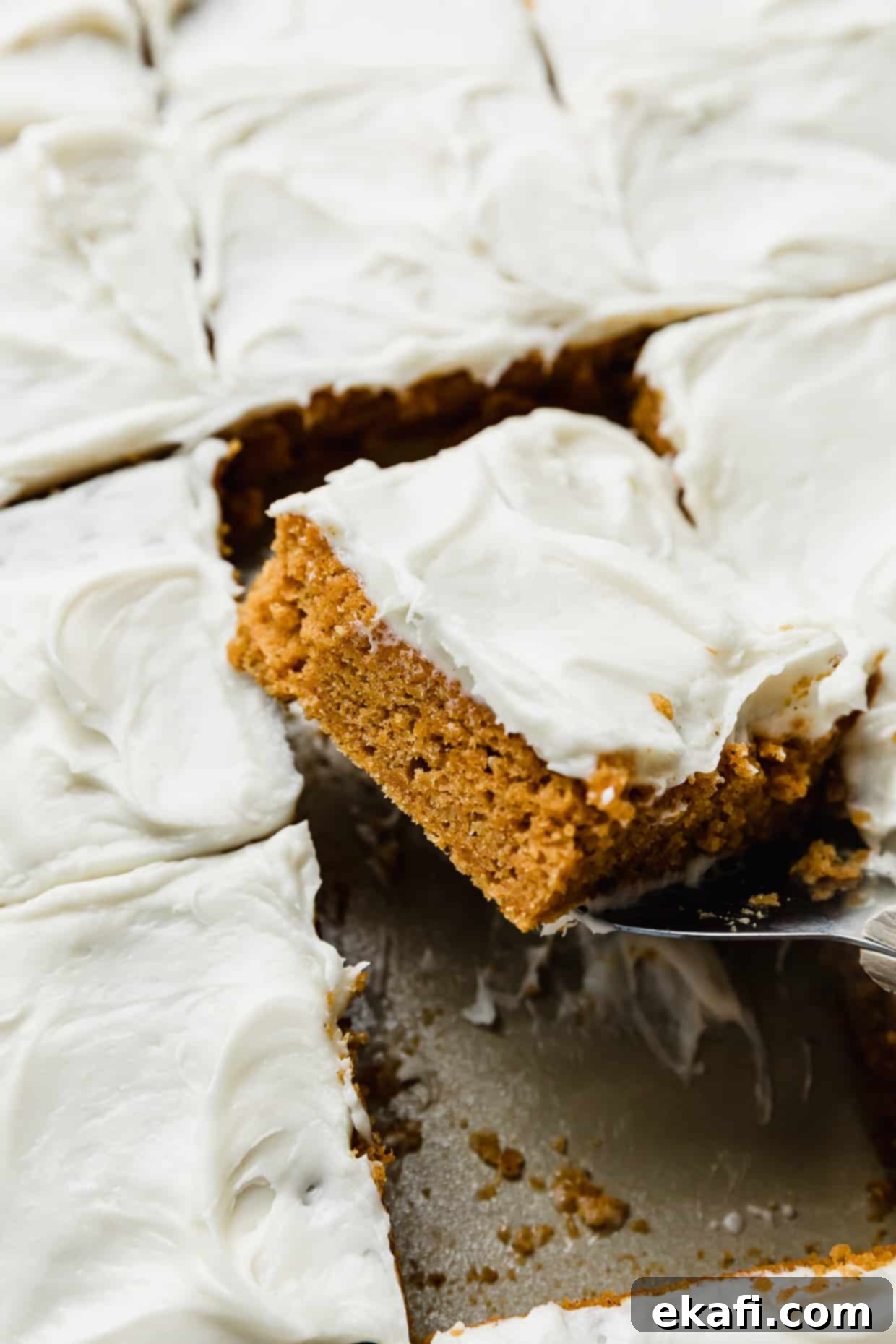 Golden Pumpkin Spice Bars 2 Perfectly cut squares of moist Libby's Pumpkin Bars topped with creamy cream cheese frosting, ready to be served.