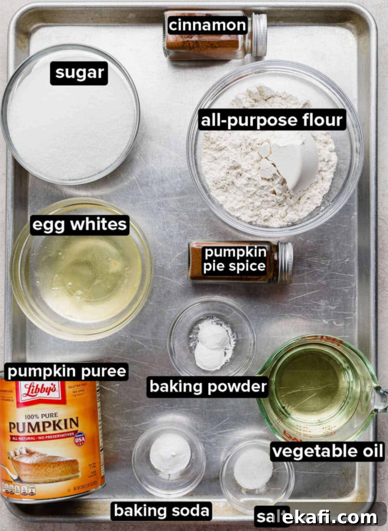 Golden Pumpkin Spice Bars 3 Arrangement of dry and wet ingredients including Libby's pumpkin puree, spices, flour, and eggs, all portioned in glass bowls, ready for the best pumpkin bars recipe.