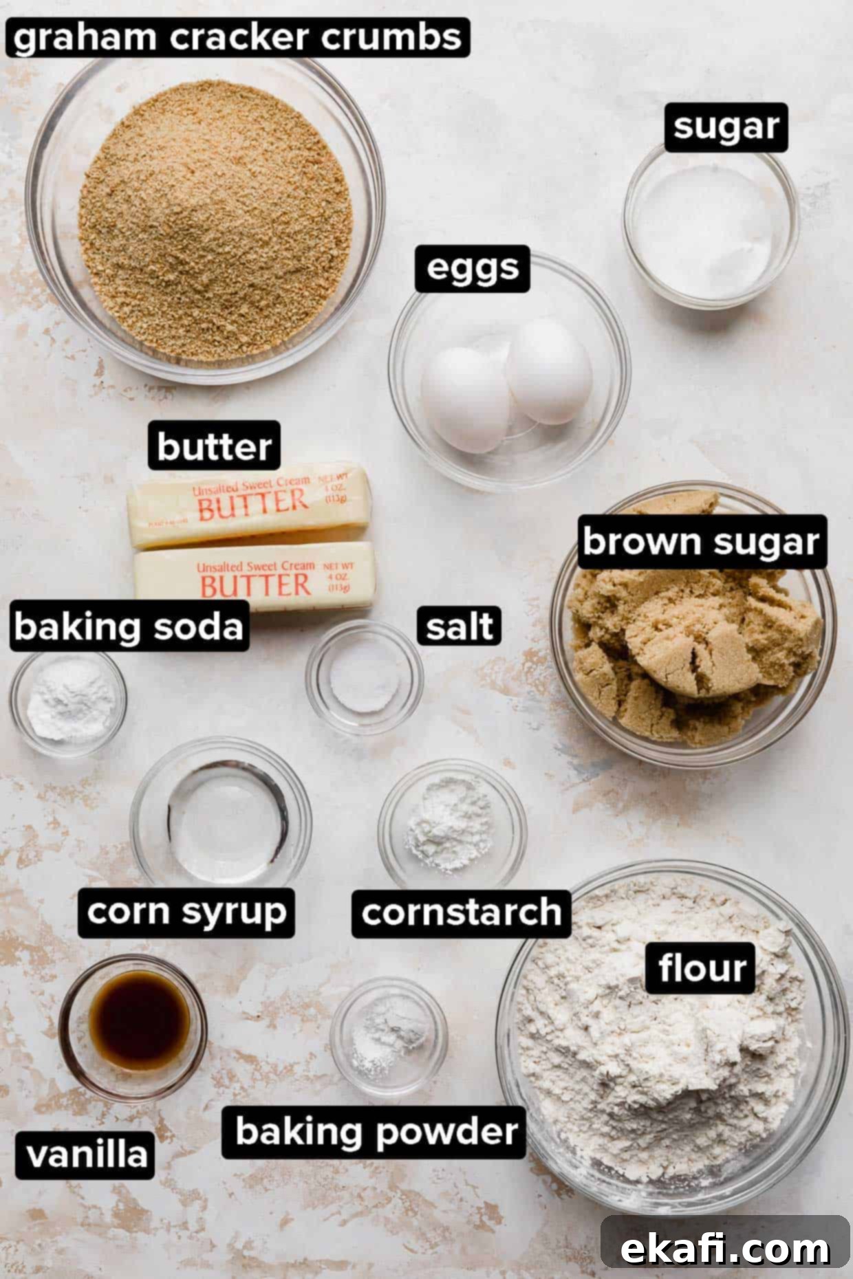 Sweet Graham Cracker Delights 3 Graham Cracker Cookie ingredients portioned into glass bowls on a white and cream textured background.