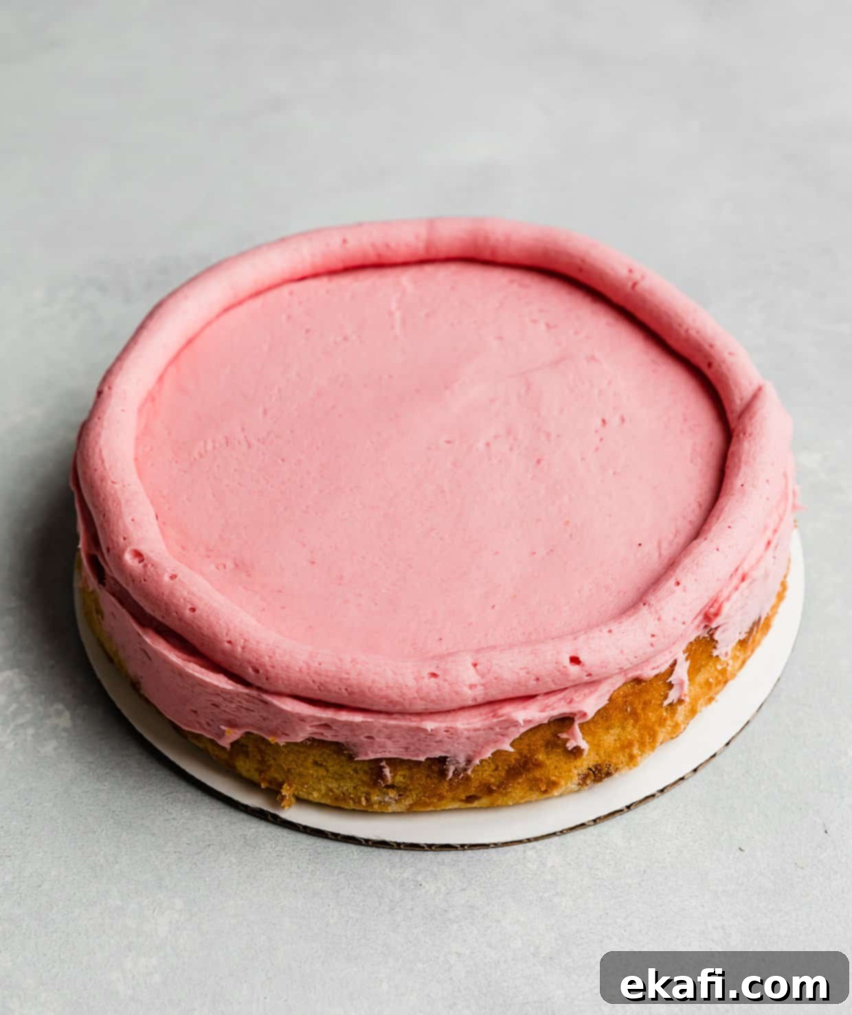 Perfect Lemon Raspberry Cake 7 A Lemon Raspberry Cake round with a raspberry buttercream piped around the perimeter.